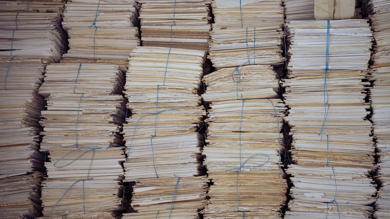 Bundles of waste paper stacked ready for paper recycling